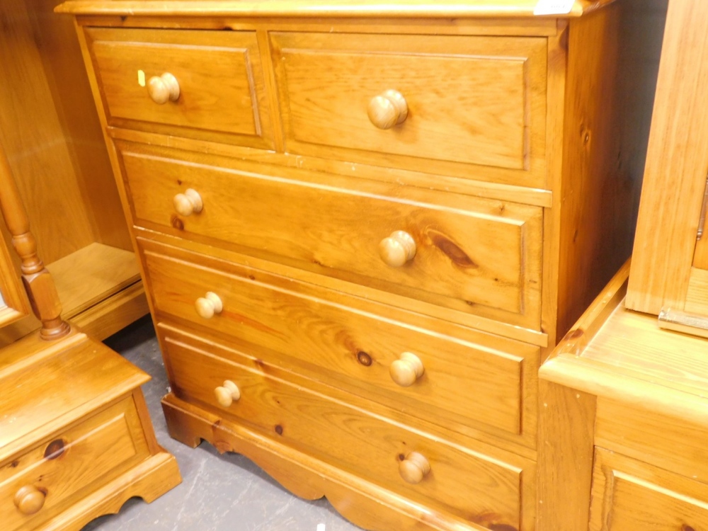 A pine chest two short and three long drawers on a plinth.