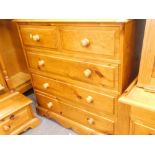 A pine chest two short and three long drawers on a plinth.