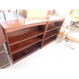 A pair of mahogany effect open bookcases, each on a plinth base.