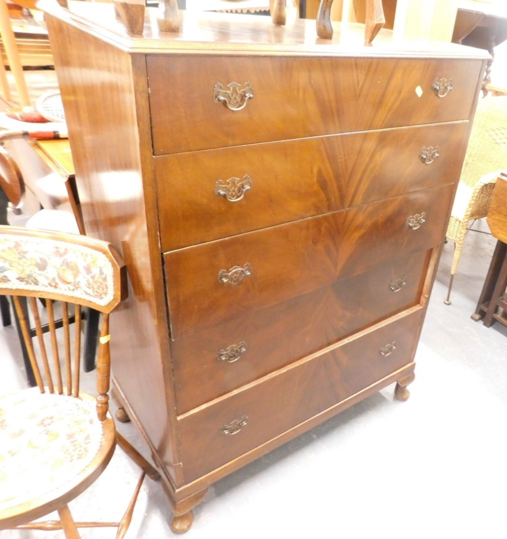 A figured mahogany chest of drawers, topped with a moulded edge above five drawers on short cabriole