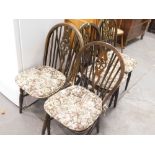 A set of four Old Charm style stained beech wheel back kitchen chairs.