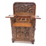 An Eastern hardwood cocktail cabinet, the hinged lid carved to the underside with a scene of warrior