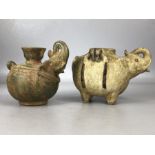 Two clay pouring jugs with applied elephant head spouts, the largest on four feet and approx 11.