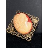 Unusual Cameo on red background mounted on a gold coloured filigree Brooch. 27mm square