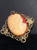 Unusual Cameo on red background mounted on a gold coloured filigree Brooch. 27mm square