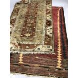 Two Eastern woollen rugs, the largest approx 217cm x 125cm