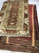 Two Eastern woollen rugs, the largest approx 217cm x 125cm