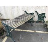 Wooden garden table with green painted metal ends, together with two pairs of green metal bench