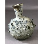 Possibly Roman small green glass bottle with protruding nodules, approx 10cm in height