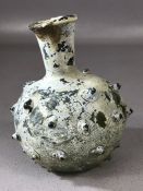 Possibly Roman small green glass bottle with protruding nodules, approx 10cm in height