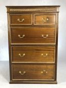 Tall chest of three large and two small drawers with carved detailing and brass handles. approx 87cm