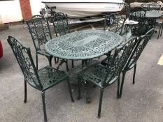 Green painted oval garden table and six chairs, table approx 138cm in length