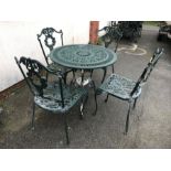 Green painted round garden table and four chairs, table approx 80cm in diameter
