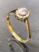 9ct Gold Ring set with an Oval Aquamarine and sourrounded by Diamonds size approx 'O'