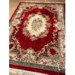 Large Chinese woollen hand made red ground rug, approx 270cm x 375cm