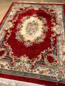 Large Chinese woollen hand made red ground rug, approx 270cm x 375cm