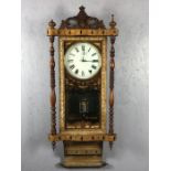 Edwardian wall clock with inlaid and carved detailing, turned supports and ornate pendulum, with