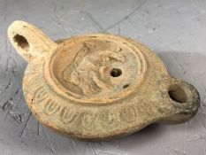 Ancient Roman terracotta oil lamp with central discus decorated with a wild bore, makers mark to