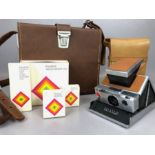 VINTAGE POLAROID SX-70 LAND CAMERA with tan leather coverings and original leather case and
