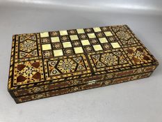 Inlaid folding backgammon set with backgammon pieces in an inlaid Middle Eastern design, approx 40cm