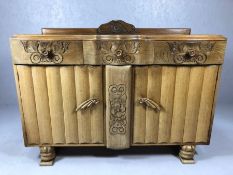 Heavily carved linen fold sideboard with three drawers and two large cupboards, on carved feet