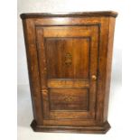 Shelved oak corner cupboard with inlaid design, approx height 98cm