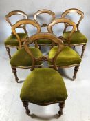 Set of six Victorian balloon back dining chairs on reeded front legs with green upholstered seats