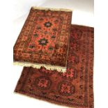Two small Eastern red ground rugs, the largest approx 155cm x 117cm