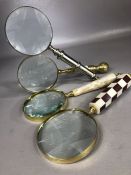 Collection of four magnifying glasses with decorative handles in varying designs, each approx 25cm