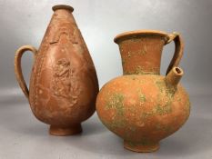 Two antique terracotta jugs, the smaller with internal strainer and pouring spout, the larger approx