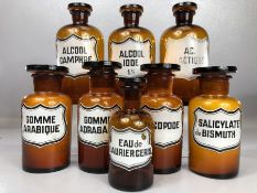 Collection of eight French vintage glass apothecary / chemist bottles with stoppers, the tallest