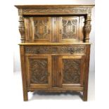 Court cupboard with two drawers and four cupboards in heavily carved American oak by furniture maker
