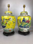 Pair of Chinese porcelain ginger jars decorated with Butterflies, flora and fauna on a yellow