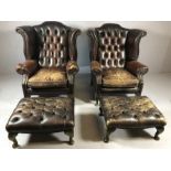 Pair of leather upholstered wingback fireside armchairs with button backs and matching foot