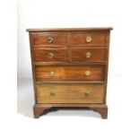 Cabinet with two drawers and pair of faux drawers opening to cupboard with brass circular handles,