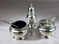 Silver cruet set with blue glass lined salt, pepper and a Mustard pot and spoon, hallmarked