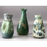 Collection of three glass bottles, possibly Roman, of various designs, the largest approx 11cm in