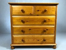 Modern pine chest of five drawers on bun feet, approx 85cm x 39cm x 80cm tall