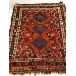 Vintage woollen red/orange ground rug, approx 190cm x 160cm