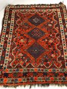 Vintage woollen red/orange ground rug, approx 190cm x 160cm