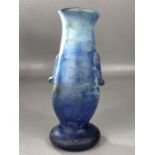 Roman blue glass vessel on circular pedestal base with two handles, crack close to rim, approx