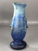 Roman blue glass vessel on circular pedestal base with two handles, crack close to rim, approx