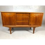 Mid Century small sized sideboard on legs with three drawers to central and cupboards to each