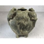 Rustic clay urn on four feet with applied elephant head decoration, approx 16cm in diameter and 16cm