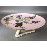 Ceramic cake stand by Mintons in the 'Essex Birds' design on pink ground, approx 24cm in diameter