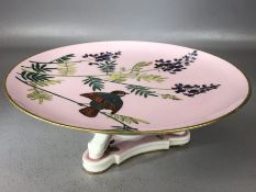 Ceramic cake stand by Mintons in the 'Essex Birds' design on pink ground, approx 24cm in diameter