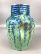 Studio pottery vase in blue and green glaze with dimpled design, approx 21cm in height, marked 34 to