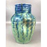 Studio pottery vase in blue and green glaze with dimpled design, approx 21cm in height, marked 34 to