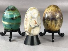 Collection of three decorative ceramic eggs on stands, the largest approx 7.5cm (inclu. stand)