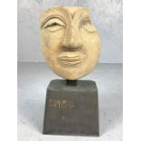 Terracotta death mask mounted on a wooden plinth, possibly Etruscan, height approx 20cm in height (
